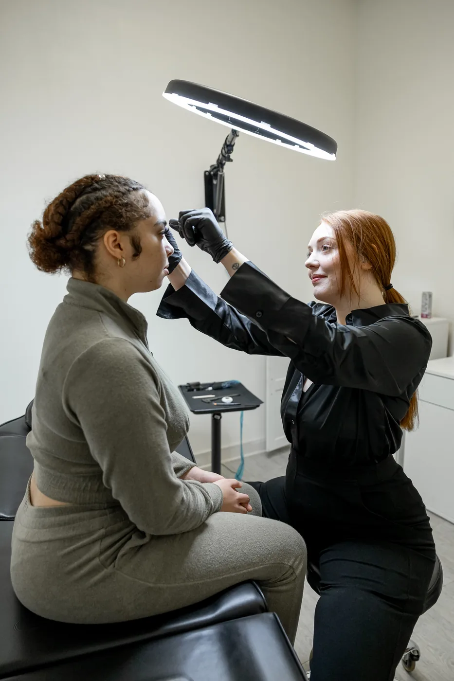 Instructor supervising a student during permanent makeup training